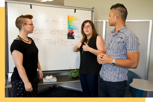 A group of people standing in front of a whiteboard