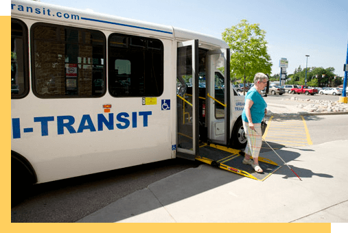 A person getting off a bus with probing cane